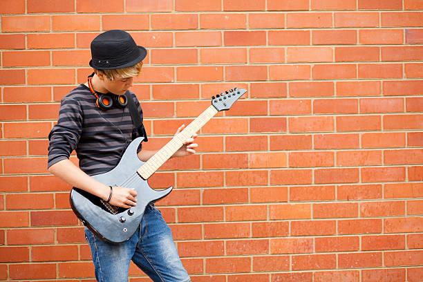 istock teen boy playing guitar 151938964