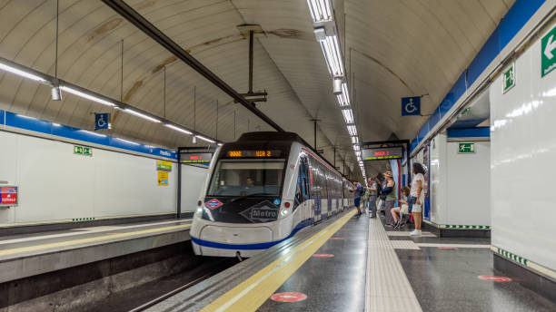 Madrid, Spain - June 26, 2023: People on the move inside a station of the Madrid metro (Metro). The Madrid Metro is an underground system that serves the city of Madrid, the capital of Spain. The system is the seventh longest subway in the world.
