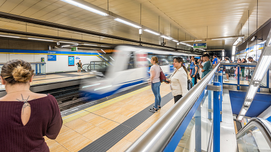 Madrid, Spain - June 26, 2023: People on the move inside a station of the Madrid metro (Metro). The Madrid Metro is an underground system that serves the city of Madrid, the capital of Spain. The system is the seventh longest subway in the world.