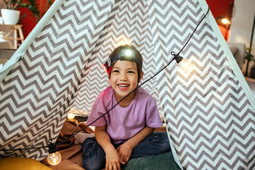 Portrait of  girl in a tent at home
