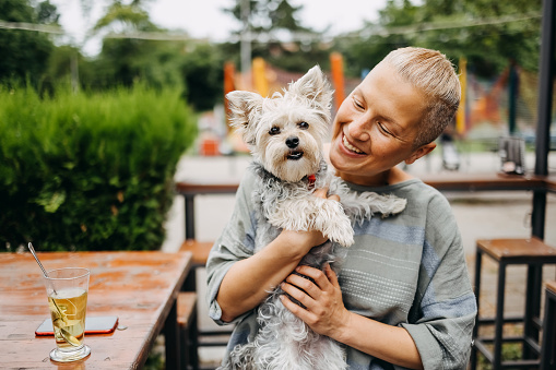 Portrait of a woman and a dog in a cafe