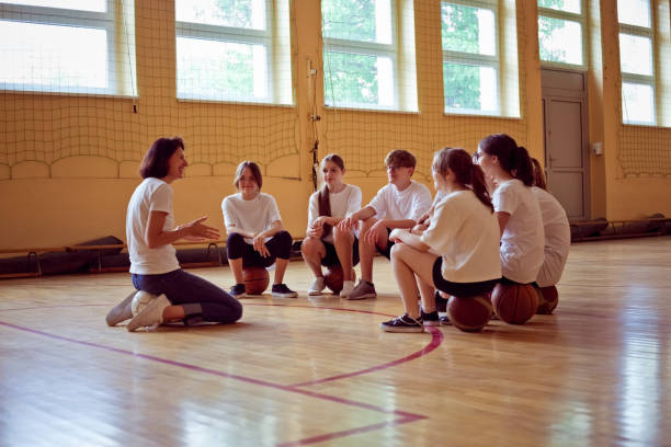 istock High school students talking with female teacher in gym 1519430184