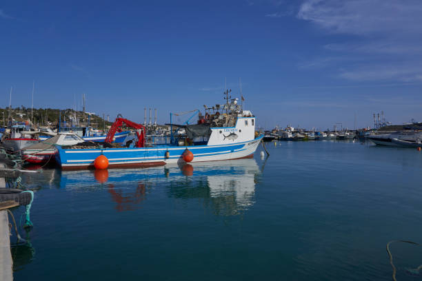 Marsaxlokk, Malta - June 7, 2023: Traditional fishing boats in the harbour of the historic fishing town of Marsaxlokk in Malta