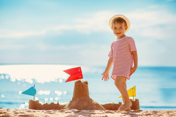 istock Little boy building sand castle on the sea beach. 1519455382
