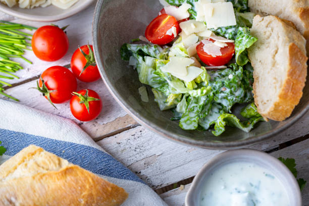 istock Green salad with tomatoes, bread and parmesan cheese 1519458702