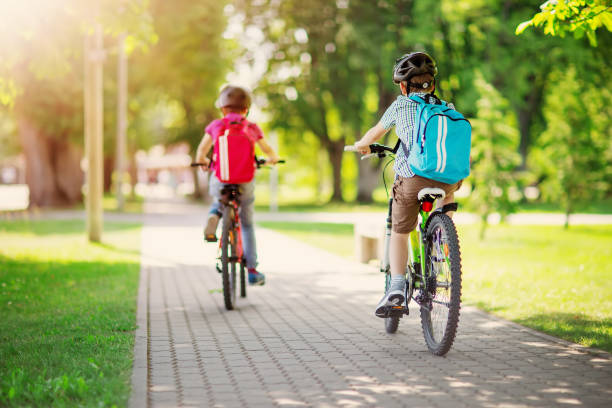 istock Two boys with backpacks on bicycles going to school. 1519459796