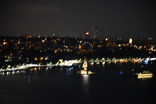 A long-exposure photograph of a beautifully-lit cityscape at night.