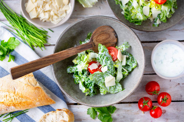istock Green salad with tomatoes, bread and parmesan cheese 1519460862