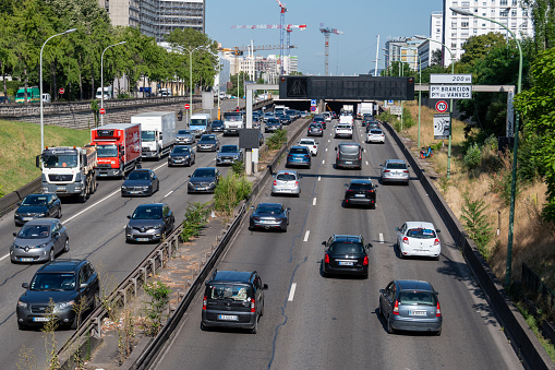 Paris, France - July 6, 2023: View of vehicle traffic on the Paris Boulevard Peripherique at Porte Brancion and Porte de Vanves. The boulevard Périphérique, also called Périph', is a ring road circling Paris