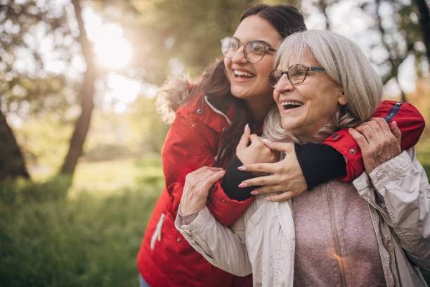 giovane donna con la nonna in natura - grandparent senior adult senior women multi generation family foto e immagini stock