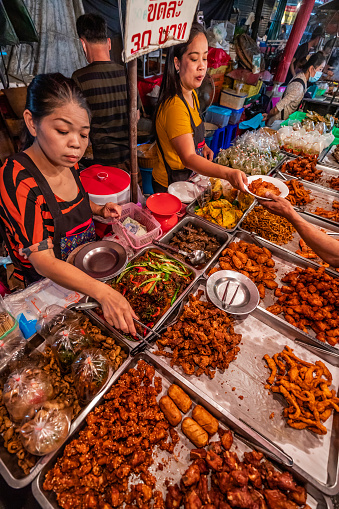 Thai street food sellers at the night market in Chiang Mai, Northern Thailand