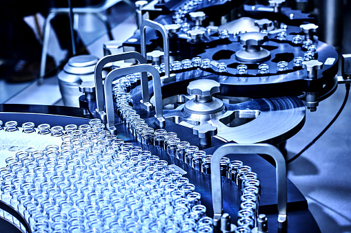 Close-up of the large group transparent glass bottles at production line.