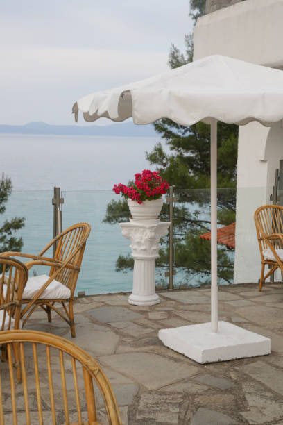 istock Mediterranean style balcony with parasol and chairs with sea view 1519607697