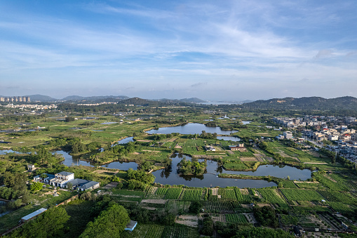 Aerial view of aquaculture farms and farmland houses in the town