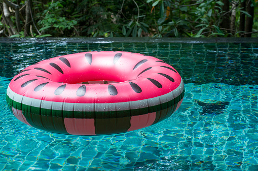 Watermelon floaties in pool on summer with copy space