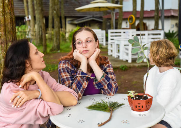 Multi-generation family with young baby have a fun dinner party outdoors on back deck