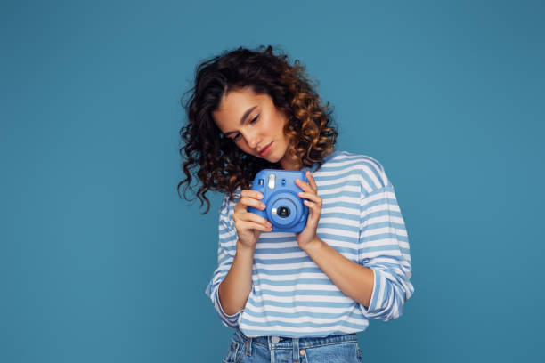 istock Happy beautiful woman with analog camera 1519709184