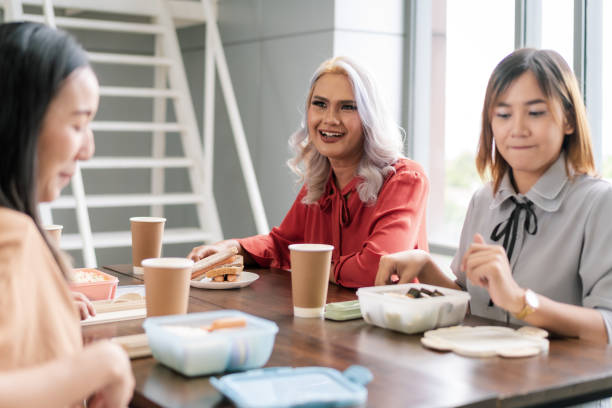 istock Office worker enjoying lunch at work together 1519717835