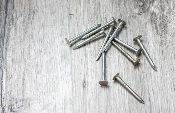 istock Sharp screw nails on wooden floor, top view 1519719545