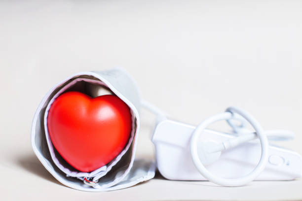 istock Red heart and white electronic tonometer isolated on beige background 1519741784