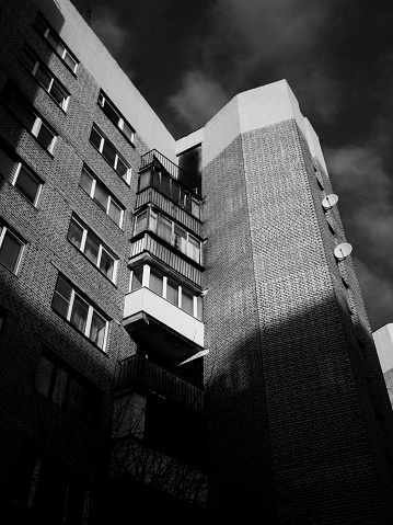 Corner of a house with a balcony, shadows, architecture, sky