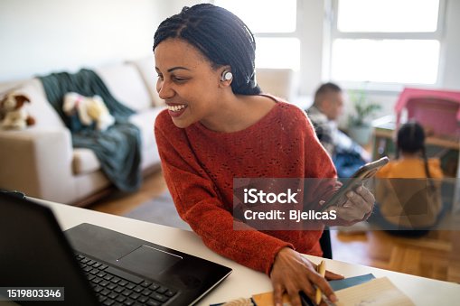 istock Woman remotely working at home while spending time with her family 1519803346