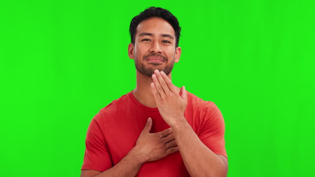 Communication, sign language and Asian man on green screen for thank you, gratitude and grateful. Deaf, chromakey studio and portrait of male person with hand on chest for signing, symbol and speech