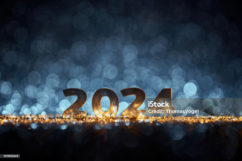 Happy New Year 2024 - Christmas Gold Blue Glitter Golden numbers 2024 on wonderful defocused lights in a yellow blue contrast. Native image size: 7952x5302 2024 Stock Photo