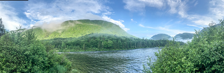 Panoramic view of Jacques Cartier Valley and river during summer day with fog in the mountain