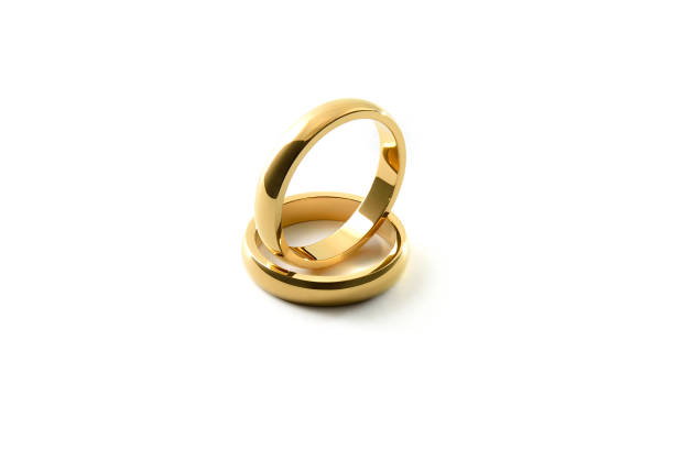 istock Engagement gold ring standing inside of each other on white isolated background 1519823045