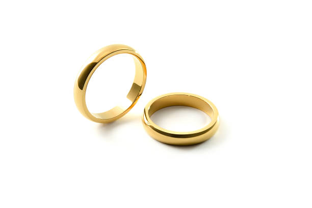 istock Engagement gold rings standing and lying down white isolated background 1519823048