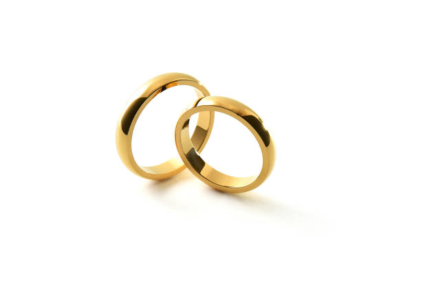 istock Engagement gold rings standing perpendicular to each other isolated background 1519823049