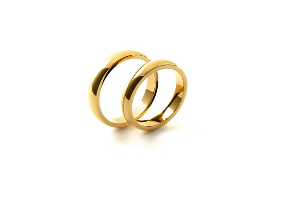 istock Engagement gold rings standing side by side white isolated background 1519823052