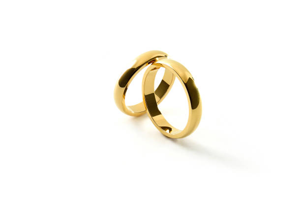 istock Engagement gold rings leaning on each other on white background 1519823059