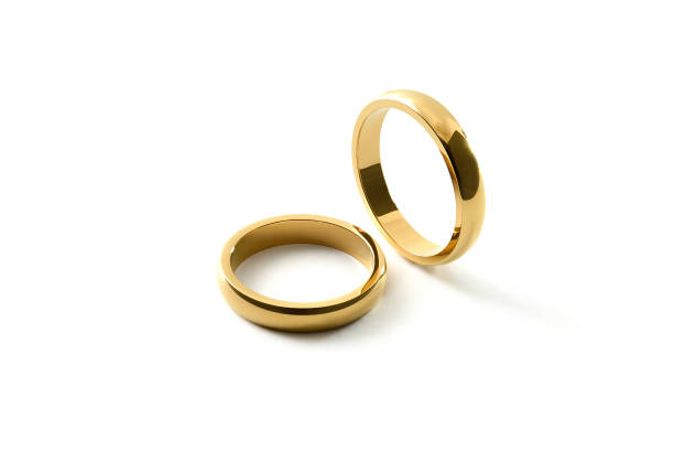 istock Engagement gold rings standing and lying down on isolated background 1519823060