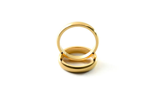 istock Engagement gold ring standing on each other isolated white 1519823241