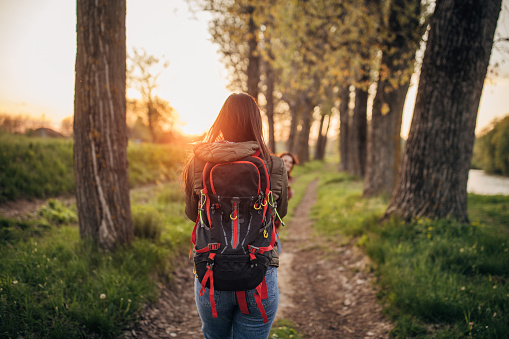 Happy young woman enjoying taking a walk in nature.