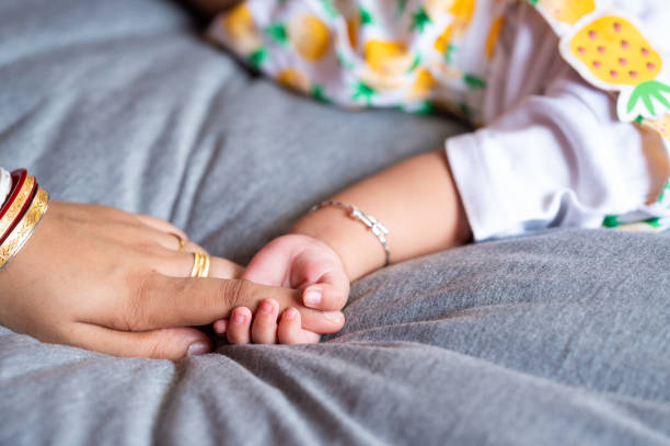 istock Toddler holding her mother hand closeup 1519838767