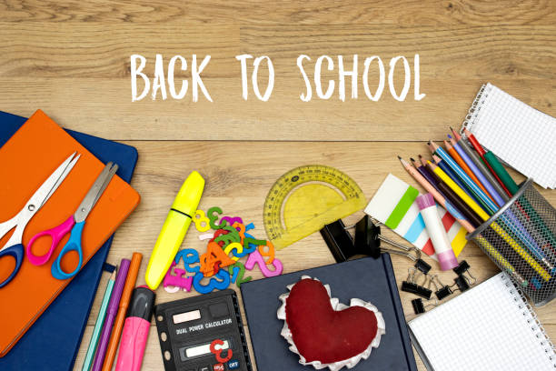 istock Back to school concept - pencil-box and books, notebooks and sticky note and calculator with pins, felt pen and heart shape on wooden table 1519839281