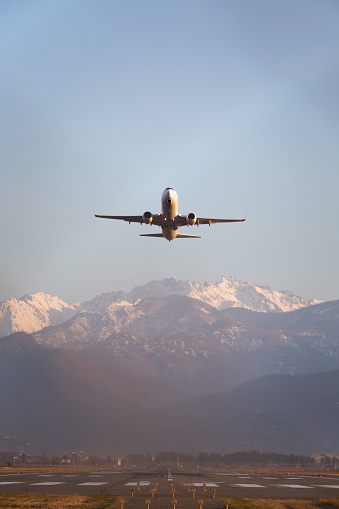 passenger airplane taking off against the backdrop of mountains