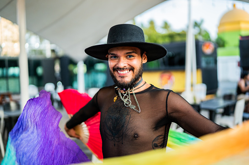 Portrait of young man with pride flag on a gay festival