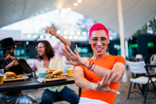 Portrait of mid adult man with friends at a food truck festival Portrait of mid adult man with friends at a food truck festival gay man men sunglasses party stock pictures, royalty-free photos & images