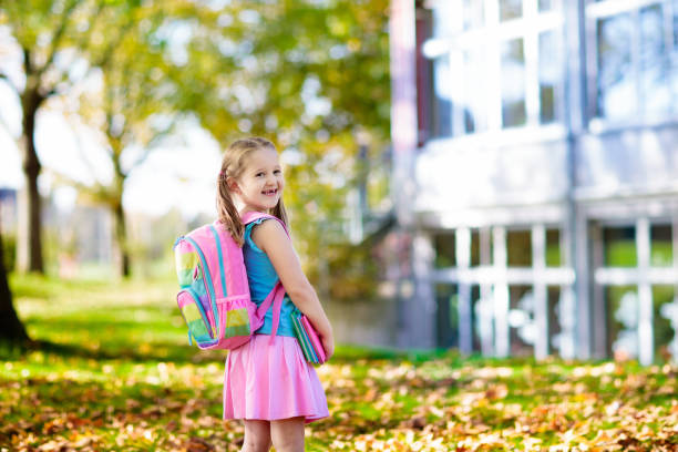 Child going back to school, year start Child going back to school. Start of new school year after summer vacation. Little girl with backpack and books on first school day. Beginning of class. Education for kindergarten and preschool kids. first grade classroom stock pictures, royalty-free photos & images