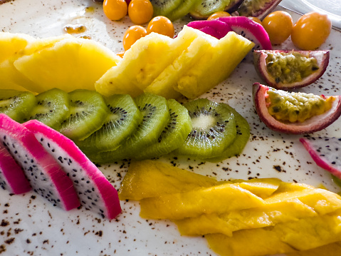 Set of sliced fruits, mango,  kiwi,  pineapple, passion fruit, pitaya or dragon fruit