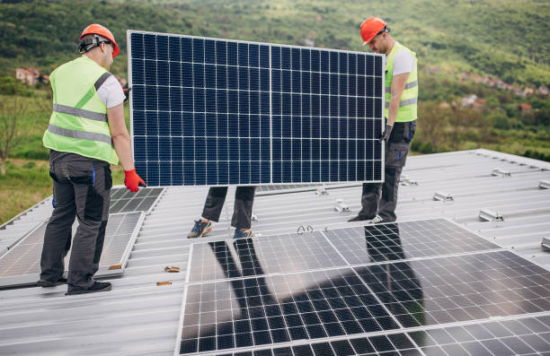 istock Solar panels installers on the roof 1519923153