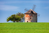 Old windmill on green hill in South Moravia, Czech Republic.