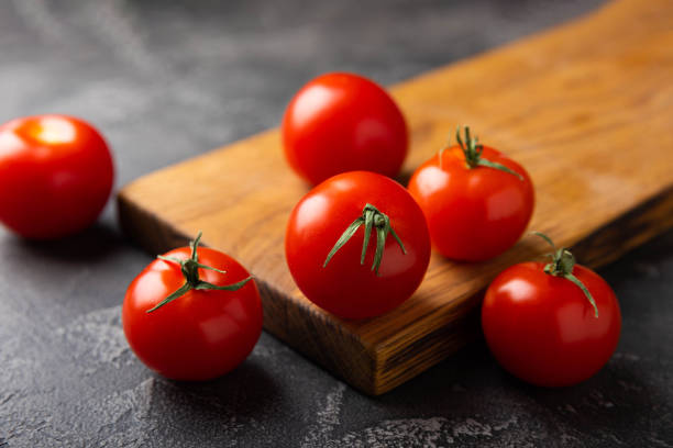 istock Fresh red tomatoes on  texture marble background. Cherry tomatoes with green stems. Fresh vegetables. Place to copy.organic food 1519940988