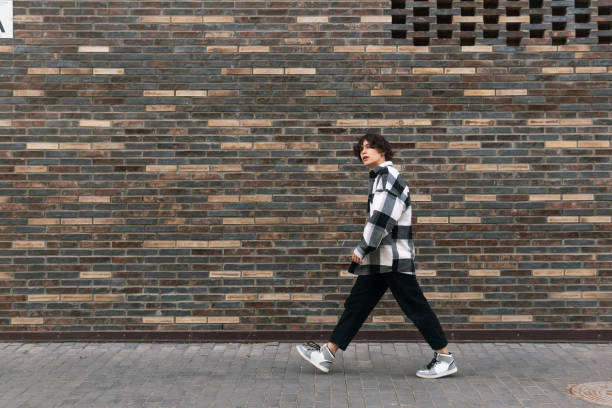 istock young man walks down the street in front of a brick wall 1519944553