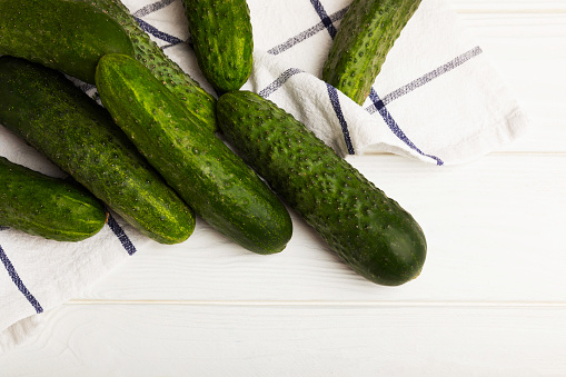 Fresh cucumbers on texture wood. Vegetarian organic vegetables.Ingredient for salad. Healthy food.Copy space.Place for text