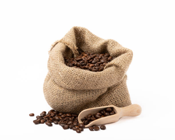 istock Coffee beans in a bag isolated on white background. 1519957891